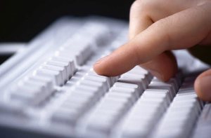 hand typing on keyboard